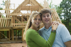 Couple embracing in front of construction site
